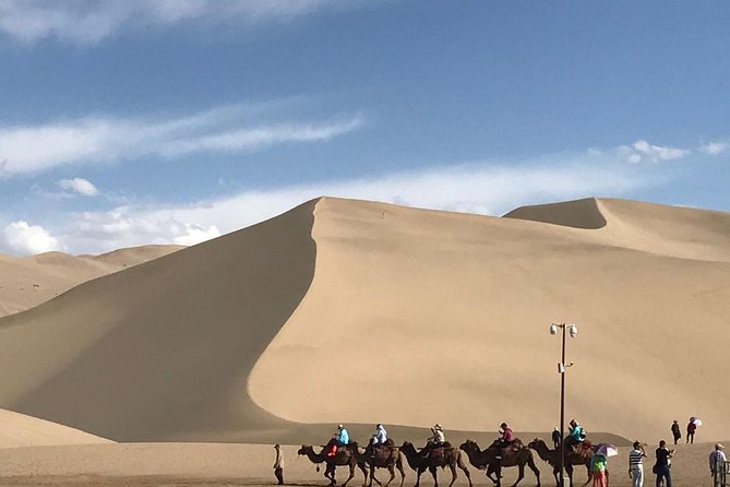 Dunhuang Private Day Tour Mogao Grottoes, Singing Dunes and Crescent Moon Spring - From painted caves to Mingsha Shan’s Singing Dunes